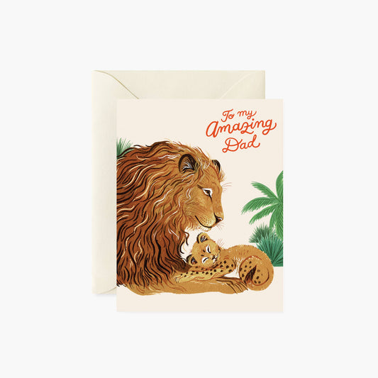 A cream father's day card with a lion and his cub nestled in front of green foliage. To my amazing dad written in orange cursive font.